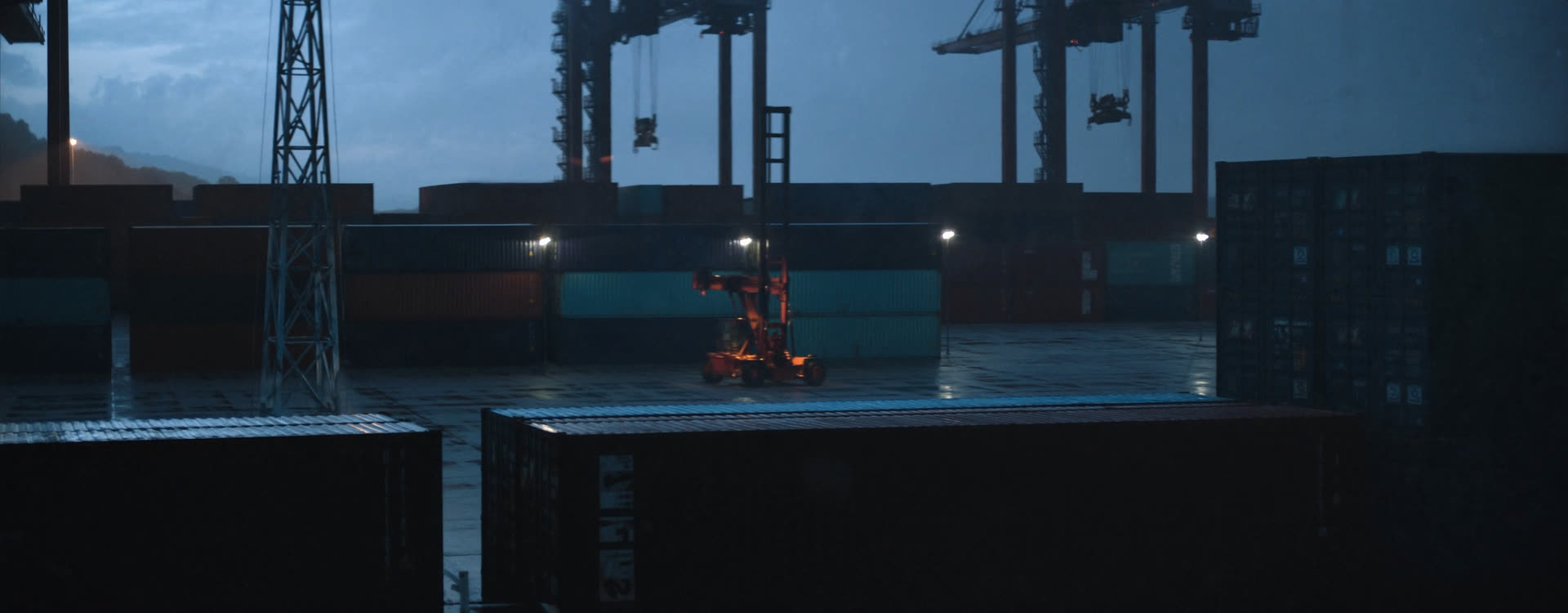 Containers stacked on a quay at dusk