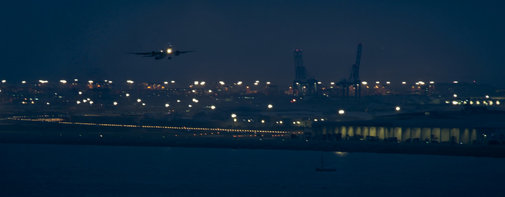 Freight aircraft and quayside cranes at night